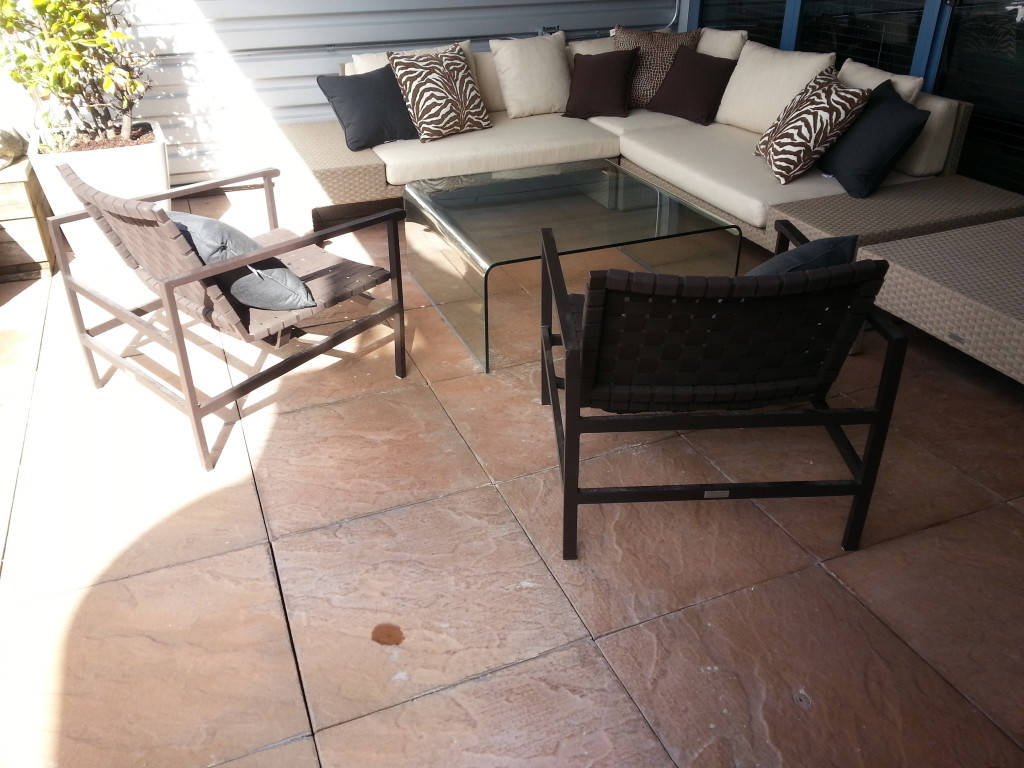 Patio deck red stone tiles returned to like new after SPM deck cleaning service